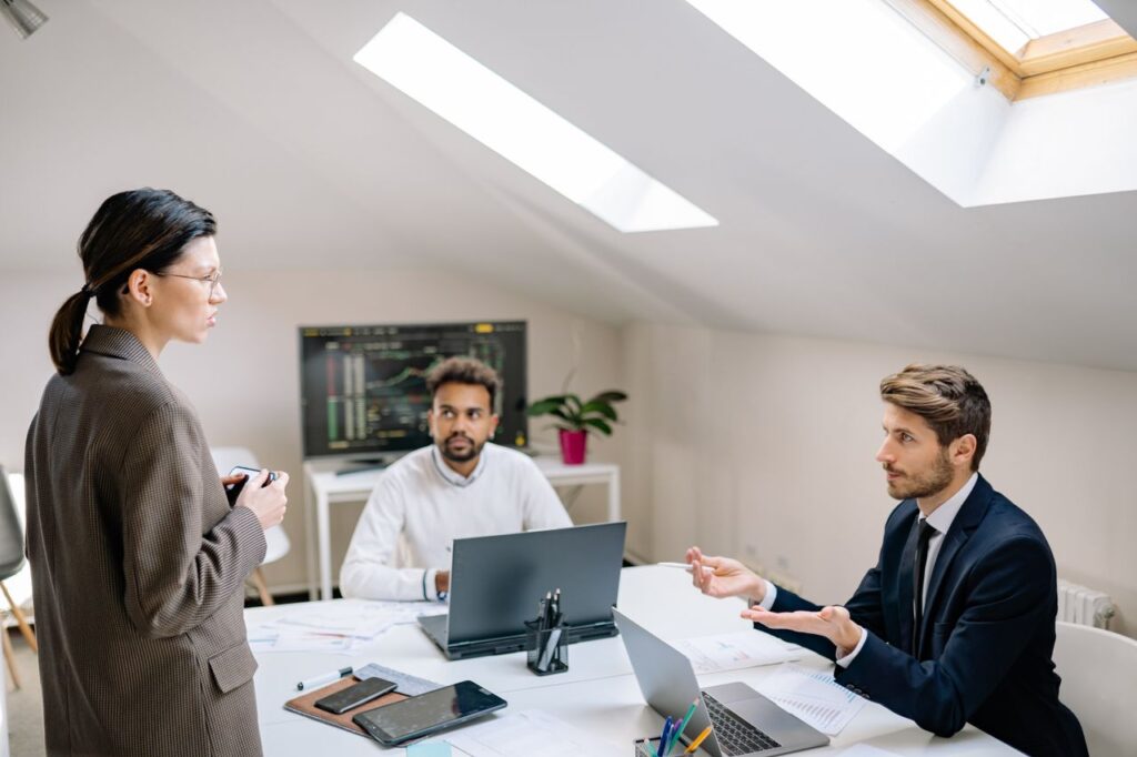 Professional meeting in a bright office space with diverse colleagues discussing ideas.